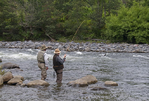 Jim guiding Michael to a trout